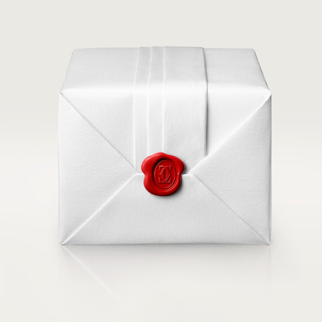 A white, neatly wrapped box with crisp folds is sealed with a red wax seal featuring an embossed design—ideal for gifting a Cartier Santos-Dumont watch with a refined steel case—set against a plain light background.